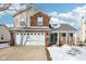 Brick two-story house with a white garage door and green front door at 6350 W Chelmsford Dr, McCordsville, IN 46055