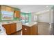 Kitchen with wood cabinets, island, and eat-in area at 6350 W Chelmsford Dr, McCordsville, IN 46055