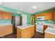 Bright kitchen with stainless steel appliances and wood cabinets at 6350 W Chelmsford Dr, McCordsville, IN 46055