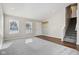 Open living room with hardwood and carpeted floors, and stairs at 6350 W Chelmsford Dr, McCordsville, IN 46055
