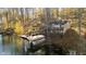 Lakefront property showcasing house and dock in autumn at 7018 Drum Dr, Nineveh, IN 46164
