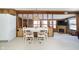 Bright dining area with white table and chairs, adjacent to kitchen at 7018 Drum Dr, Nineveh, IN 46164