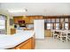 Open kitchen boasts wood cabinets, white appliances, and an island with seating at 7018 Drum Dr, Nineveh, IN 46164