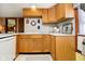 Cozy kitchen features wood cabinets, white appliances, and a charming decor at 7018 Drum Dr, Nineveh, IN 46164