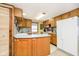 Efficient kitchen with wood cabinets and white appliances at 7018 Drum Dr, Nineveh, IN 46164