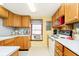 Small kitchen with wood cabinets and appliances at 7018 Drum Dr, Nineveh, IN 46164