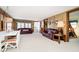 Cozy living room with wood paneling, comfortable seating, and dining area at 7018 Drum Dr, Nineveh, IN 46164