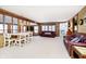 Open-concept living and dining area with wood paneling and comfortable furniture at 7018 Drum Dr, Nineveh, IN 46164