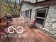 Stone house features a spacious deck, perfect for outdoor entertaining and relaxation in a wooded setting at 7018 Drum Dr, Nineveh, IN 46164
