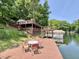 Enjoy this spacious wooden dock with seating, plus boat dock, perfect for lakeside relaxation and entertaining at 7018 Drum Dr, Nineveh, IN 46164