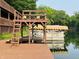 Dock view with boat lift, ladders, seating, covered boat slip, providing convenient access to the water at 7018 Drum Dr, Nineveh, IN 46164