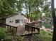 Charming stone home nestled in trees with private deck and lake access offers serene outdoor living and stunning views at 7018 Drum Dr, Nineveh, IN 46164