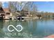 Scenic lake view surrounded by trees and homes with boat docks, perfect for enjoying waterfront living and recreation at 7018 Drum Dr, Nineveh, IN 46164