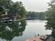 Scenic lake view with private dock and boat slip provides tranquil waterfront living amid lush green trees at 7018 Drum Dr, Nineveh, IN 46164
