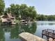 Serene lake view featuring boat docks and waterfront homes surrounded by lush greenery at 7018 Drum Dr, Nineveh, IN 46164