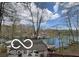 Scenic view of lakefront property with lush trees, boat docks, and the tranquility of lakeside living at 7018 Drum Dr, Nineveh, IN 46164