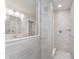 Tiled shower features glass enclosure with a view of the double sink vanity and quartz countertop at 7164 Firestone Rd, Whitestown, IN 46052