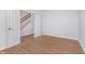 Spacious bedroom with light wood floors leading to an open doorway and glimpses of the stairway at 7164 Firestone Rd, Whitestown, IN 46052