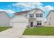 Charming two-story home with a white exterior, stone accents, a two-car garage, and a well-manicured lawn at 7164 Firestone Rd, Whitestown, IN 46052