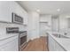 Bright kitchen featuring white cabinets, stainless steel appliances, quartz countertops, and modern fixtures at 7164 Firestone Rd, Whitestown, IN 46052