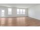 Bright living room featuring wood floors and a wall of windows providing ample natural light at 7164 Firestone Rd, Whitestown, IN 46052