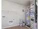 Utility room with water heater, shelving, connections, and wood-look flooring at 7164 Firestone Rd, Whitestown, IN 46052