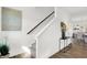 Modern staircase with dark wood railing and light walls at 733 Penrose Pl, Danville, IN 46122