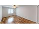 A bright bedroom featuring wood-look floors and a large window at 7468 Prairie Lake Dr, Indianapolis, IN 46256