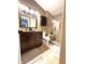 Updated bathroom with granite vanity, tiled shower, and modern fixtures at 8104 Glenwillow Ln # 208, Indianapolis, IN 46278