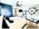 Main bedroom with king bed, hardwood floors, and decorative wall art at 8104 Glenwillow Ln # 208, Indianapolis, IN 46278