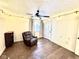 Bedroom with dark green accent wall, hardwood floors, and a comfortable seating area at 8104 Glenwillow Ln # 208, Indianapolis, IN 46278