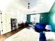 Bedroom with dark green accent wall, hardwood floors and built in shelving at 8104 Glenwillow Ln # 208, Indianapolis, IN 46278