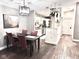 Bright dining area with wood floors and a view of the kitchen at 8104 Glenwillow Ln # 208, Indianapolis, IN 46278