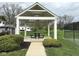 Outdoor gazebo with seating, surrounded by green space and mature landscaping at 8104 Glenwillow Ln # 208, Indianapolis, IN 46278