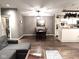 Open-concept living room features a dining area, hardwood floors, and stylish decor at 8104 Glenwillow Ln # 208, Indianapolis, IN 46278