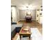 Open-concept living room features a dining area, hardwood floors, and stylish decor at 8104 Glenwillow Ln # 208, Indianapolis, IN 46278