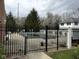 Fenced outdoor pool with lounge chairs, perfect for summer relaxation and recreation at 8104 Glenwillow Ln # 208, Indianapolis, IN 46278