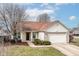 Charming single-story home with a well-maintained lawn, two-car garage, and inviting front entrance at 8346 Montgomery Ave, Indianapolis, IN 46227