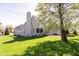 Spacious backyard features a stone patio, mature trees, and a well-maintained lawn at 10295 Summerlin Way, Fishers, IN 46037