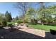 Relaxing outdoor patio area features stone pavers, comfortable seating, and a built-in fire pit for entertaining at 10295 Summerlin Way, Fishers, IN 46037
