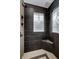 Bathroom with shower, built-in seat, and stained glass windows at 10295 Summerlin Way, Fishers, IN 46037