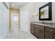 Primary bathroom with vanity, granite countertop, and walk-in closet at 10295 Summerlin Way, Fishers, IN 46037