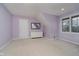 Lavender bedroom with double windows and a white dresser at 10295 Summerlin Way, Fishers, IN 46037