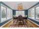 Bright dining room featuring hardwood floors, large windows, and stylish chandelier at 10295 Summerlin Way, Fishers, IN 46037