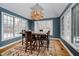 Sun-filled dining room with a large chandelier and seating for six at 10295 Summerlin Way, Fishers, IN 46037