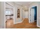 Bright hallway with hardwood floors and view into kitchen at 10295 Summerlin Way, Fishers, IN 46037