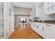 White kitchen cabinets with granite countertops and view to dining area at 10295 Summerlin Way, Fishers, IN 46037