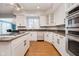 Modern kitchen featuring granite countertops, stainless steel appliances, and hardwood floors at 10295 Summerlin Way, Fishers, IN 46037