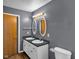 Bathroom includes double sinks, black granite countertops, two oval mirrors, and white colored cabinets at 11054 Dura Dr, Indianapolis, IN 46229