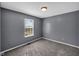 This is a room painted gray with carpet. There is a window letting in lots of natural light at 11054 Dura Dr, Indianapolis, IN 46229